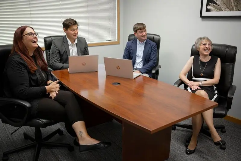 People laughing in a conference room.