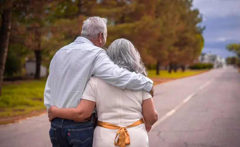 Retired couple walking down a road